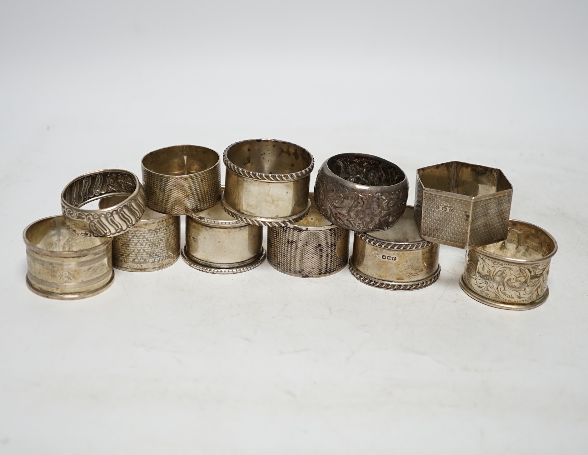 Eleven assorted early 20th century and later silver napkin rings, various dates and makers, 9.2oz. Poor to fair condition.